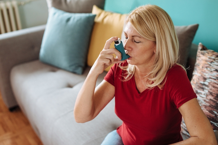 Lady with asthma using an inhaler