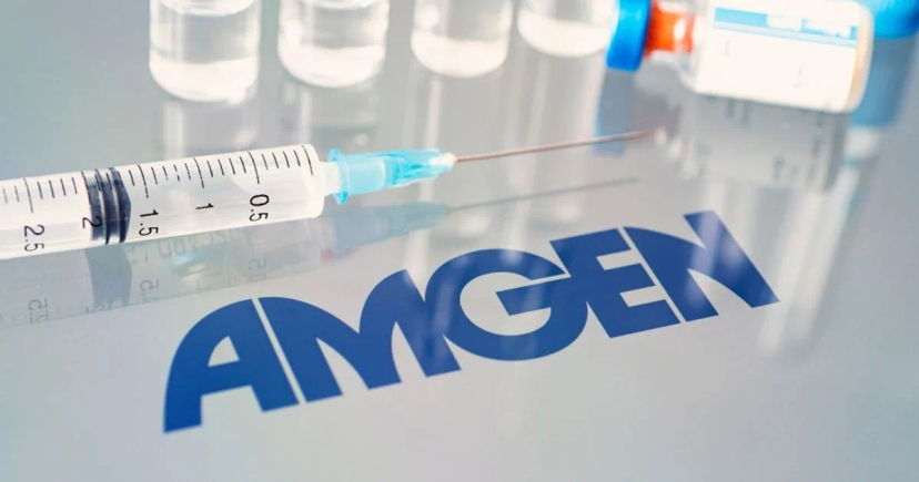 A syringe and vials on a reflective surface with the Amgen logo prominently displayed, containing the drug MariTide.