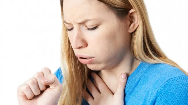 A woman coughing due to having whooping cough symptoms