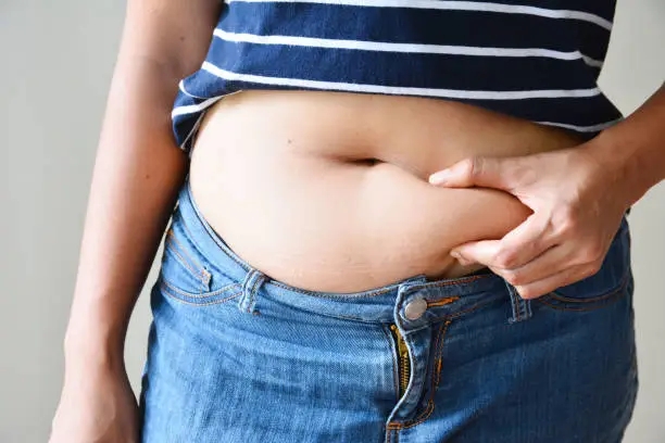 obese person holding stomach