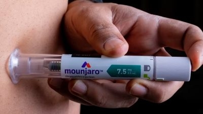 A photo of a patient injecting Mounjaro, a medication by Eli Lilly, potentially used for weight loss.