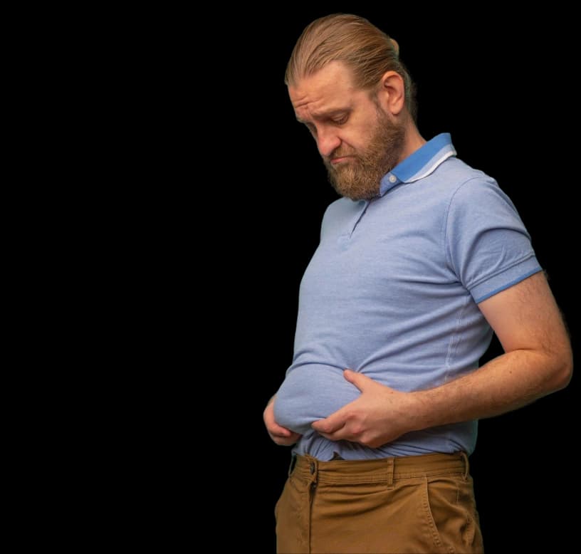 A man holding his flabby waist on a red background, representing the adiposity ratio health assessment tool
