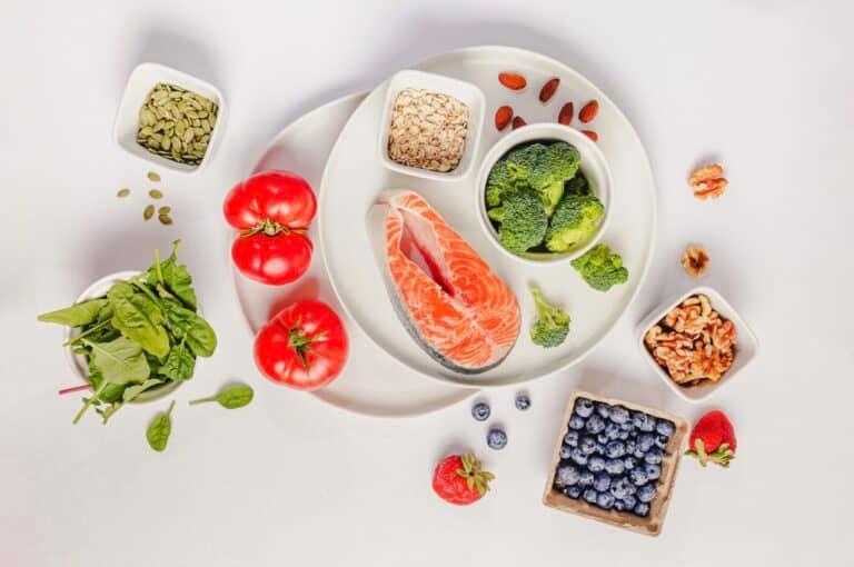 A plate of low inflammatory diet with salmon, blueberries, and vegetables