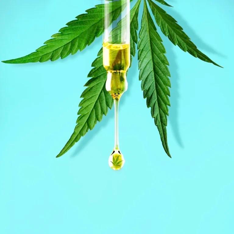 A CBD syringe on a blue background.