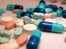 An emergency supply of medication from the NHS, represented by a pile of pills on a table.