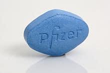 A blue pill with the word Pfizer on it, offering lower risk.