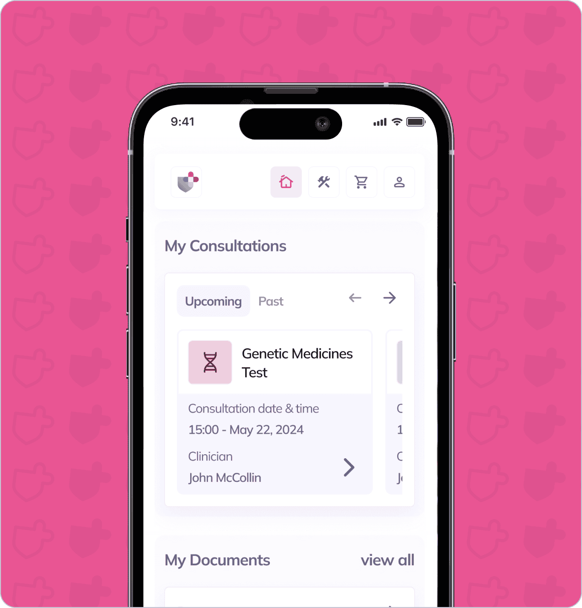 A smartphone screen displays a medical app with a "Genetic Medicines Test" consultation scheduled for May 22, 2024, under the "My Consultations" section. The background is pink with faint shield icons.