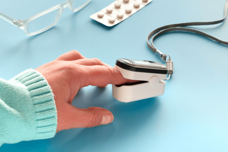 A woman's hand holding a blood pressure cuff used to measure heart conditions.
