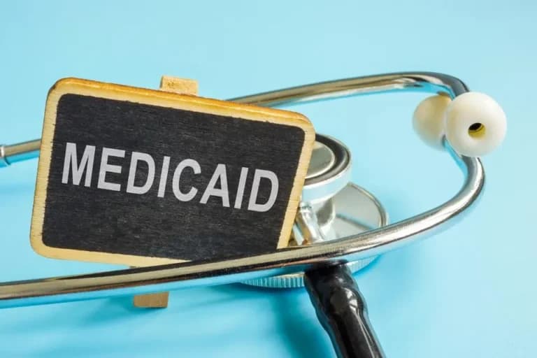 A stethoscope next to a sign that says Medicaid in North Carolina.