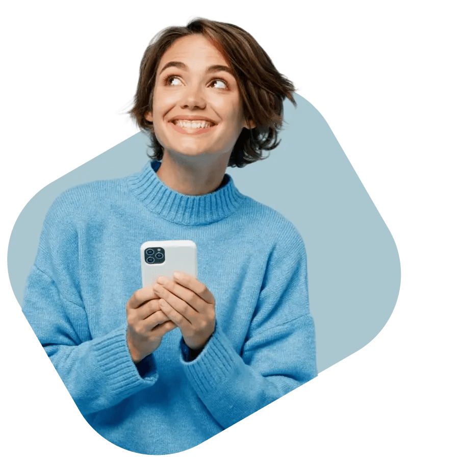 A smiling woman in a blue sweater holding a smartphone, exploring NowPatient's private health insurance quotes from FCA-regulated partners.