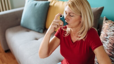 Lady with asthma using an inhaler