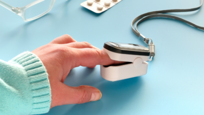 A woman's hand holding a blood pressure cuff used to measure heart conditions.