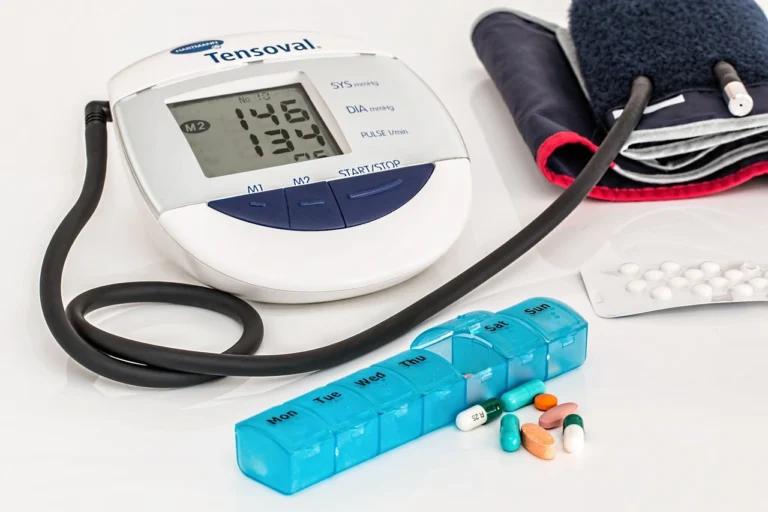 A blood pressure monitor accompanied by medications for managing blood pressure.