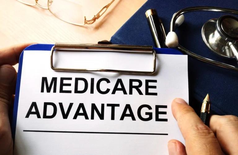 A person holding a clipboard comparing Medicare Advantage plans.