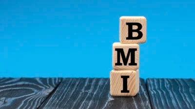 A wooden block with the word bmi stacked on top of it showcases the consequences of an imbalanced BMI.