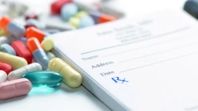A prescription form with Johnson & Johnson pills and pills on it, offering prescription drug savings.