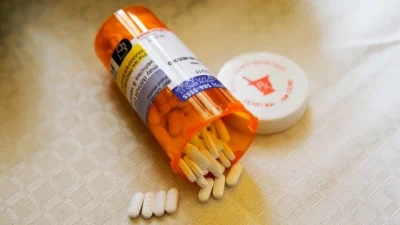 An Astellas pill bottle with prescription drug savings.