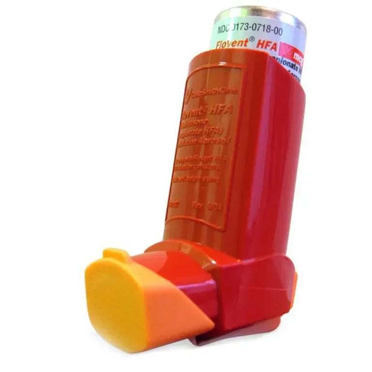 A red and orange Flovent inhaler on a white background.