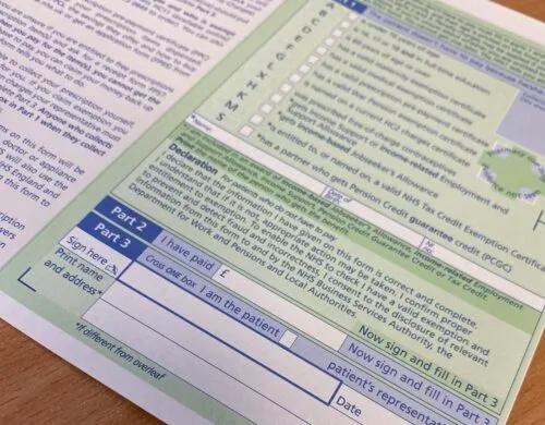 An NHS prescription form on a table.