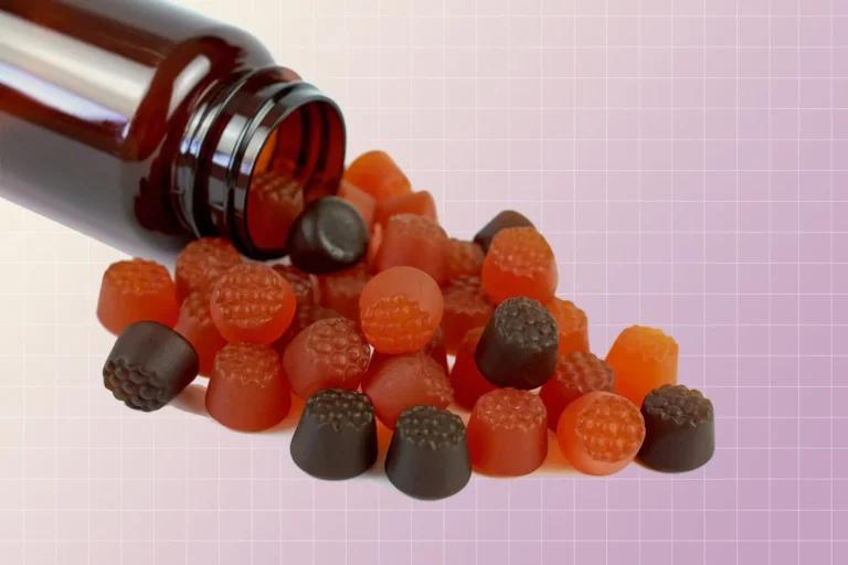 A colorful assortment of vitamin gummies on a purple background.