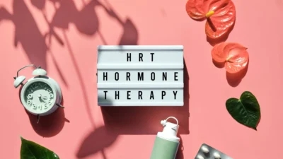 Hot hormone therapy on a pink background with plants and a clock. Introducing Auto Draft - an innovative approach to hormonal balance.