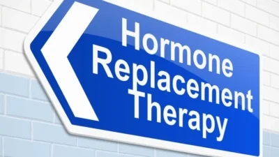 A blue and white sign advertising hormone replacement therapy, a potential treatment for cancer patients.