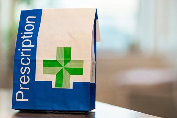 A bag exempt from paying prescriptions sits on a table.