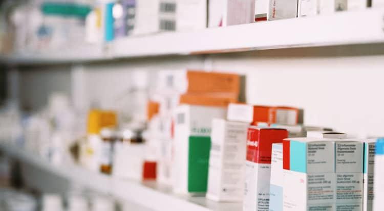 Amycretin medication boxes lined up on pharmacy shelves.