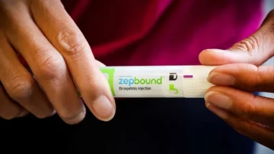 A person holding a pen with the word zepbound on it.