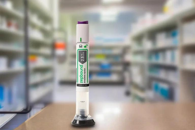 A digital handheld pipette on a stand, displaying a volume of 2.5 ml, placed on a counter with a blurred pharmacy shelf background, covered with a Zepbound material for enhanced durability