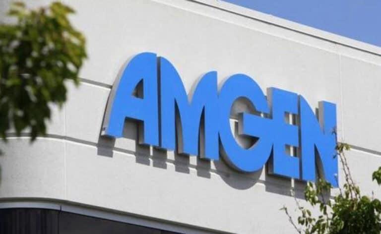 Blue "MariTide" logo on the exterior of a building under a clear sky, partially obscured by green foliage on the left side.