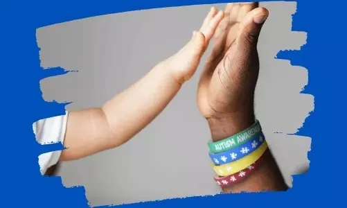 A child's hand is giving a high-five to an adult's hand. The adult, supporting the cause, is wearing colorful bracelets, including one labeled "Autism Awareness." Both hands are framed by a blue border with brushstroke edges.