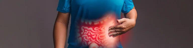 Person holding their stomach, with a highlighted digestive tract area, representing the question "Is Crohn's disease hereditary?