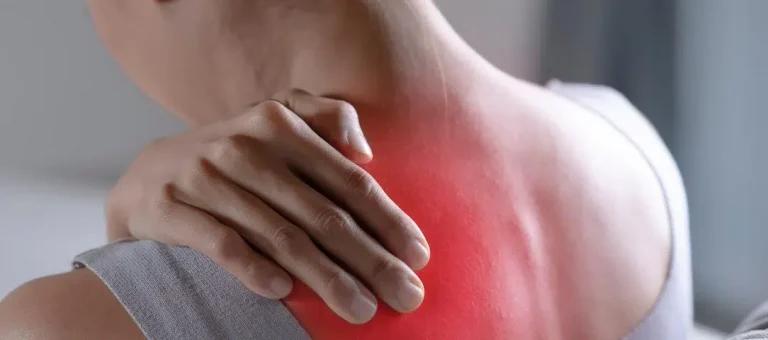 The image shows a person holding the back of their neck, where a red area highlights pain or discomfort. This visual suggests muscle or nerve pain, commonly associated with fibromyalgia