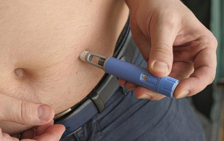 A patient injecting weight loss pen